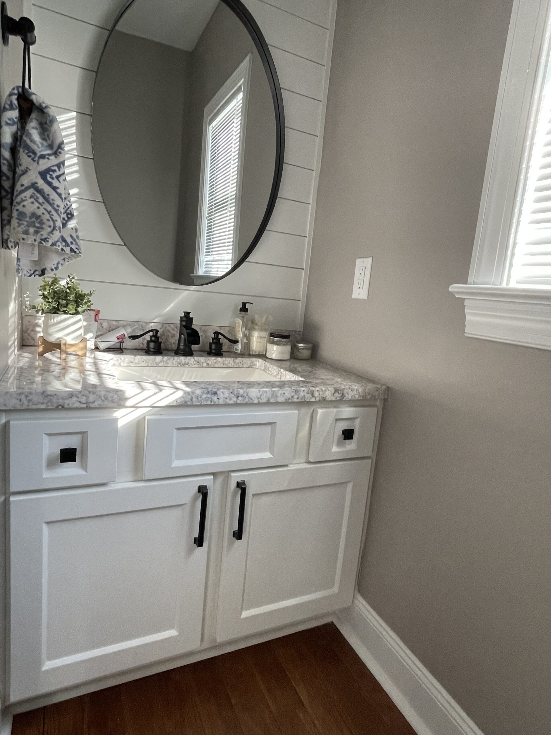 updated bathroom vanity with oval mirro